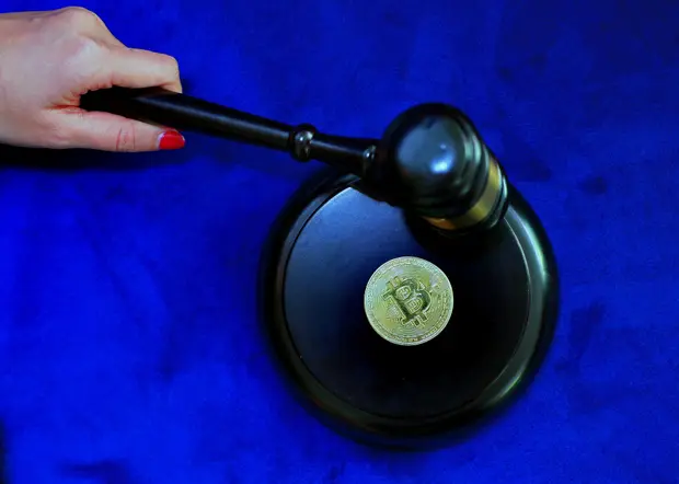 Documents and a gavel representing state financial regulation of cryptocurrency